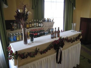 setting up liquor bottles behind a banquet bar