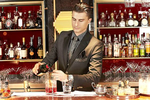 bar manager pouring drinks