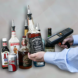 scanning the barcode of a liquor bottle to improve the accuracy of the inventory process
