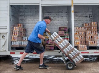 man delivering beer to a bar