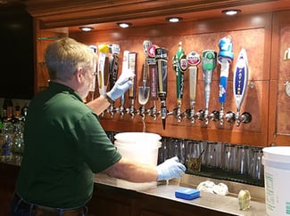 bartender cleaning the draft beer lines