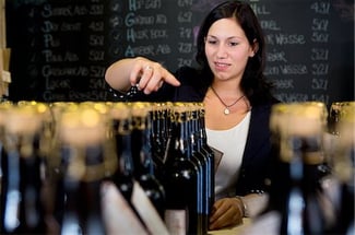 bar manager counting liquor inventory