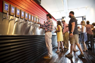 customers pouring their own beer at an iPourit self serve draft beer system