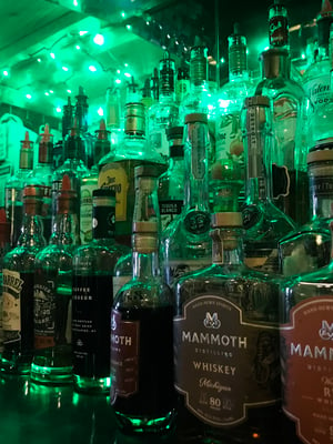 liquor bottles behind a bar before an inventory count is performed