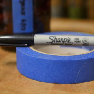masking tape and black sharpie to label liquor storeroom shelves