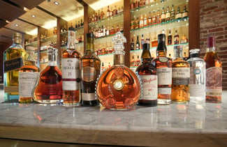 whiskey bottles organized on a bar